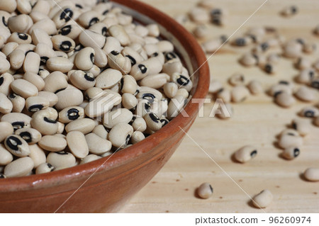 Uncooked Black Eyed Peas in Bowl on Wooden Table Uncooked Black Eyed Peas in Bowl on Wooden Table 96260974