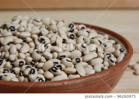 Uncooked Black Eyed Peas in Bowl on Wooden Table Uncooked Black Eyed Peas in Bowl on Wooden Table 96260975