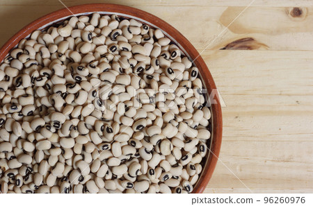 Uncooked Black Eyed Peas in Bowl on Wooden Table Uncooked Black Eyed Peas in Bowl on Wooden Table 96260976