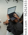 Cropped image of professional businesswoman working at her office via laptop, young female manager using portable computer devic 96262433