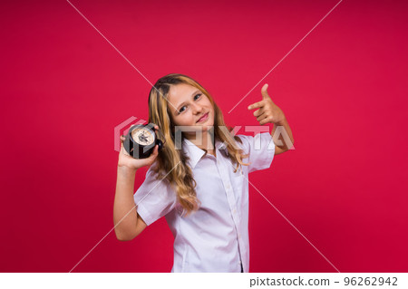 Young Girl holding an antique clock over red background 96262942