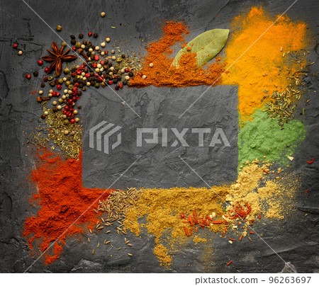 Various seasonings and spices frame on black stone plate. Various seasonings and spices frame on black stone plate. 96263697
