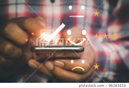 A man use mobile for check mark icon and face emoticon 96263810