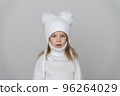Portrait of beauty kid girl in wooly sweter and hat. 96264029