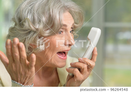 Elderly woman holding her hand to her throat. Disease Elderly woman holding her hand to her throat. Disease 96264548