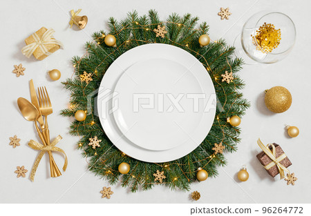 Christmas empty table setting with golden accessories on gray background. View from above. Space for text. 96264772