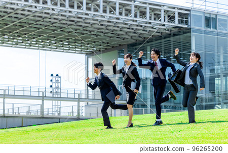 Businesswoman and businessman lined up under blue sky Businesswoman and businessman lined up under blue sky 96265200