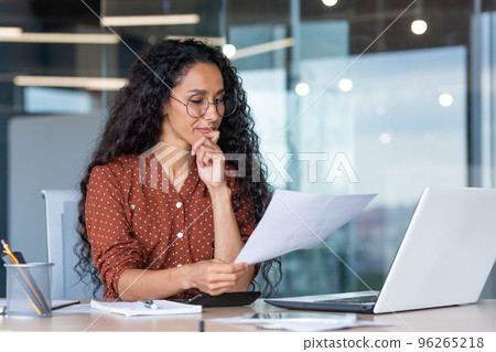 Successful satisfied and happy business woman working inside modern office, hispanic woman in glasses and shirt using laptop at work, Successful satisfied and happy business woman working inside modern office, hispanic woman in glasses and shirt using laptop at work, 96265218