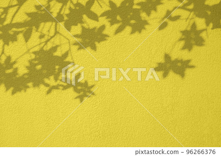 Plant leaves shadow on yellow concrete wall texture background Plant leaves shadow on yellow concrete wall texture background 96266376