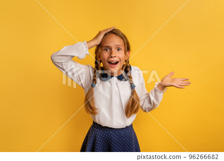 Young student is amazed about something . Yellow studio background Young student is amazed about something . Yellow studio background 96266682