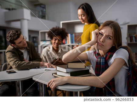 Tired university student has difficulty to study. Concept of stress, question and difficulty 96266853