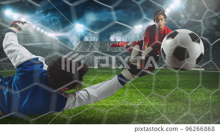 Soccer striker hits the ball with a head shot in the air at the stadium 96266868