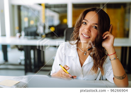 Young operator woman agent with headsets working in a call centre. 96266904