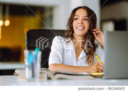 Young operator woman agent with headsets working in a call centre. Young operator woman agent with headsets working in a call centre. 96266905