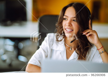 Young woman, student, teacher, business woman wear wireless headset video conference. Young woman, student, teacher, business woman wear wireless headset video conference. 96266906