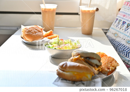 The meal in the camper is a hamburger, hash browns and a fresh salad. The meal in the camper is a hamburger, hash browns and a fresh salad. 96267018