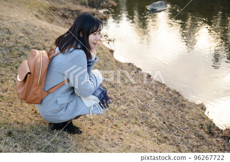 Woman enjoying winter park 96267722
