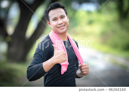 Young healthy Chinese boxing man workout in the park, looking at camera and raised thumbs up, good health concept. Young healthy Chinese boxing man workout in the park, looking at camera and raised thumbs up, good health concept. 96268160