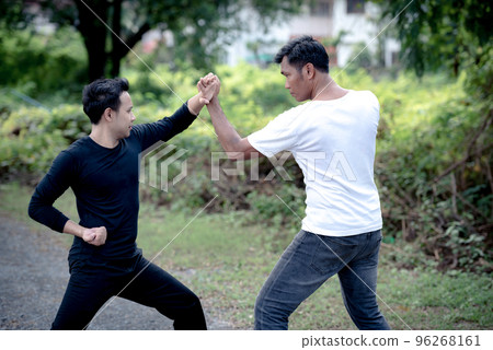 Young man training self defense fighting technique.. 96268161