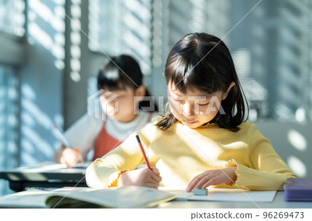 Elementary school students studying in the classroom. Elementary school students studying in the classroom. 96269473