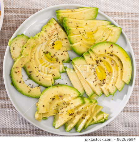ripe avocado pulp cut into pieces sprinkled with lemon juice on a plate 96269694