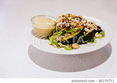 Fresh organic vegetable salad on white bowl with salad dressing. Fresh organic vegetable salad on white bowl with salad dressing. 96270751