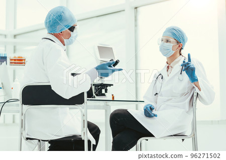 close up. biologists discussing something in the lab. close up. biologists discussing something in the lab. 96271502