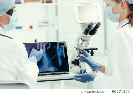 close up. attending doctors discussing x-rays in the laboratory. close up. attending doctors discussing x-rays in the laboratory. 96271503