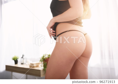 Sexy woman at home with black loincloth in a Stock Photo