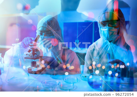 Doctor in the laboratory analyzes samples under a microscope. Pharmaceutical treatment concept. 96272054