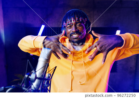 Young African performer recording his new track in recording studio Young African performer recording his new track in recording studio 96272250