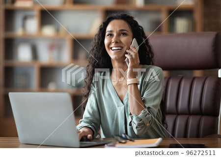 Friendly pretty middle eastern young businesswoman having phone call 96272511