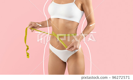 Weight Loss Concept. Slim Female In Underwear Measuring Waist With Tape Weight Loss Concept. Slim Female In Underwear Measuring Waist With Tape 96272571
