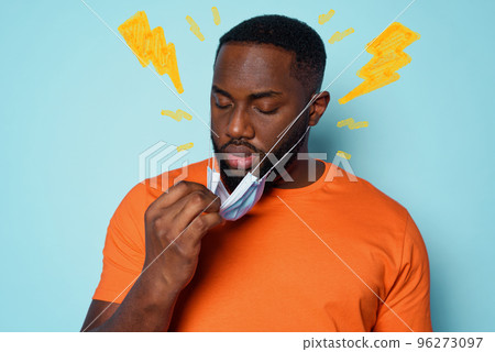 Boy is tired to breathe through the mask. cyan background Boy is tired to breathe through the mask. cyan background 96273097