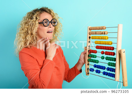 Girl with abacus is confused about the sum . cyan background Girl with abacus is confused about the sum . cyan background 96273105