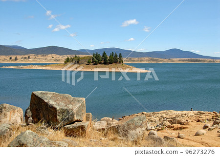 Jindabyne, New South Wales, Australia: View over Lake Jindabyne with rocks in the foreground. Jindabyne is a tourist destination near the Snowy Mountains. 96273276