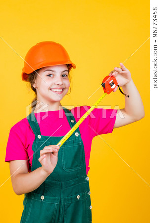 length. construction worker with tape measure. Cute kid as a construction worker. kid repairing home. happy childhood. self-retracting metal tape measure. Little girl using a measuring tape length. construction worker with tape measure. Cute kid as a construction worker. kid repairing home. happy childhood. self-retracting metal tape measure. Little girl using a measuring tape 96273458