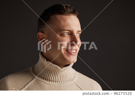 Portrait of handsome man posing in stylish sweater isolated over dark grey studio background. Deep look. Concept of fashion and lifestyle Portrait of handsome man posing in stylish sweater isolated over dark grey studio background. Deep look. Concept of fashion and lifestyle 96273520