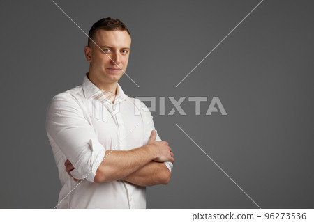 Portrait of young man posing in white shirt isolate dover grey studio background. Businessman. Startup. Success 96273536
