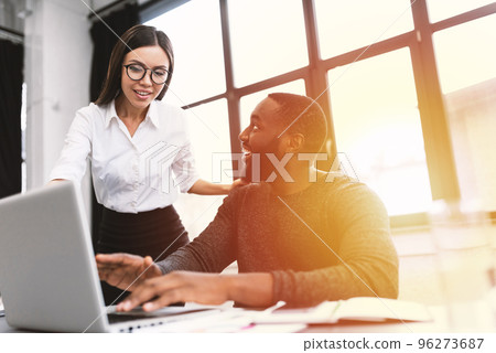 Young and heterogeneous co-workers working with pc in the office Young and heterogeneous co-workers working with pc in the office 96273687