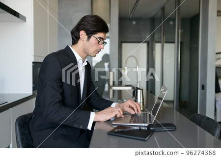 Man teleworker works at home with a laptop 96274368