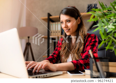 Girl teleworker works at home with a laptop 96274421