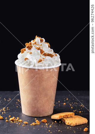 Paper cup with hot drink with whipped cream on dark background. Recycling and eco friendly concept. Paper cup with hot drink with whipped cream on dark background. Recycling and eco friendly concept. 96274426