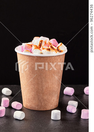 Paper cup with hot drink with marshmallows on dark background. 96274436