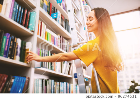 Girl choose a book to read. Concept of culture and studying. 96274531