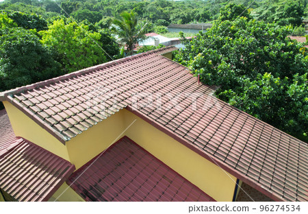 Old red tile home roof 96274534