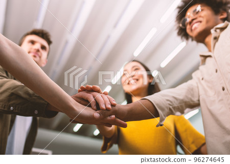 Business people putting their hands together. Concept of teamwork and partnership 96274645