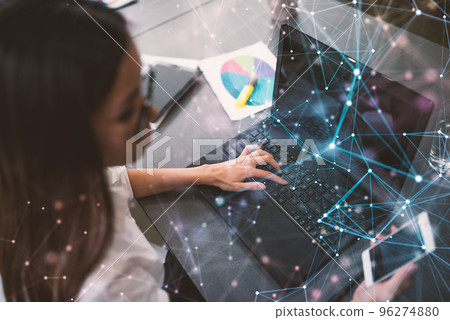 Businesswoman works in office with a laptop with internet effects. Concept of internet sharing and company startup Businesswoman works in office with a laptop with internet effects. Concept of internet sharing and company startup 96274880