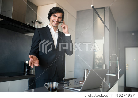 Businessman works from remote at house with a laptop due to coronavirus quarantine. Businessman works from remote at house with a laptop due to coronavirus quarantine. 96274957