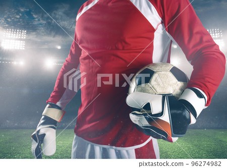 Goalkeeper ready to play with ball in his hands at the stadium Goalkeeper ready to play with ball in his hands at the stadium 96274982